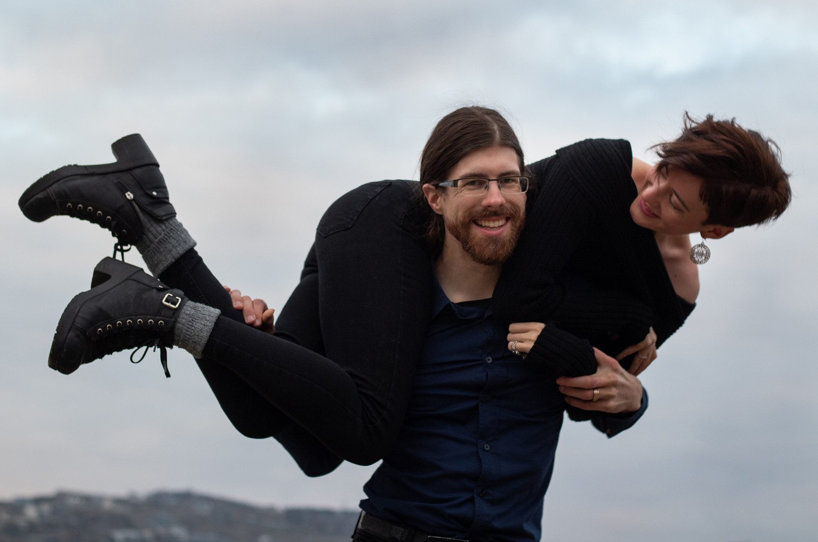 Me slung unceremoniously over the shoulders of my grinning spouse on a hilltop.